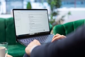 Digital marketer using ChatGPT AI tool for content creation, SEO, social media marketing, and campaign automation on a laptop.